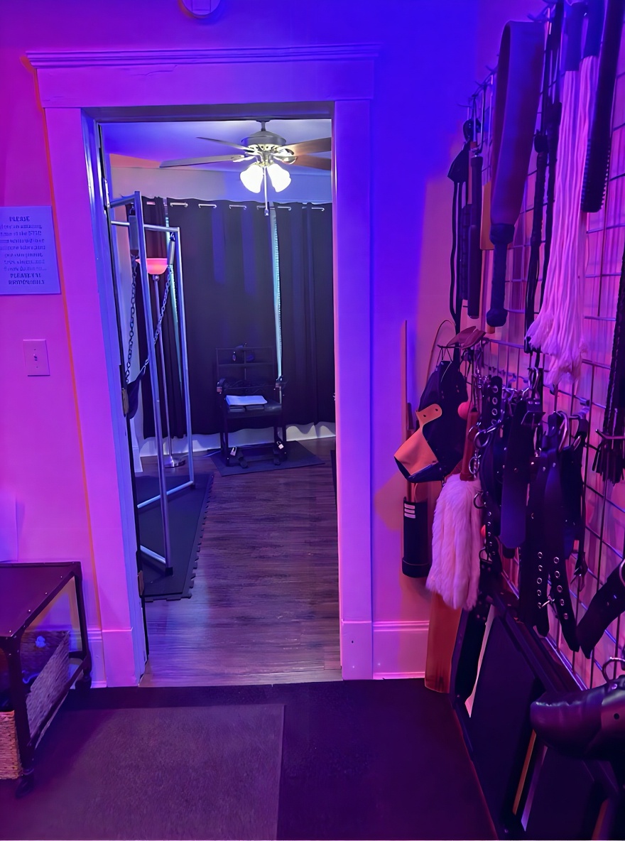 Hallway view into mirrored play room with sling