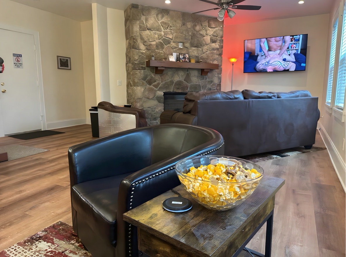 Main lounge with stone fireplace and leather seating