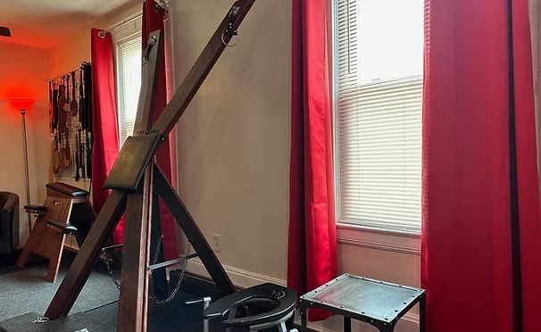 St. Andrew's cross beside crimson curtains