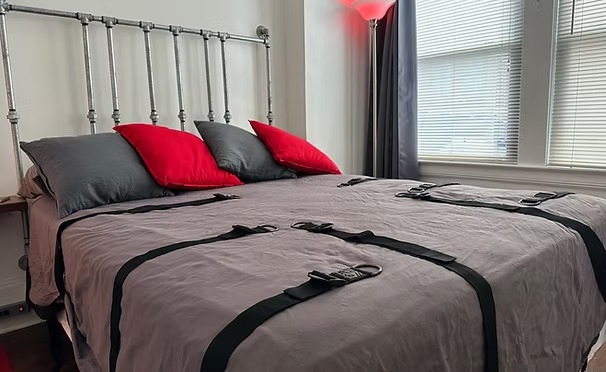 Bondage bed with industrial pipe headboard
